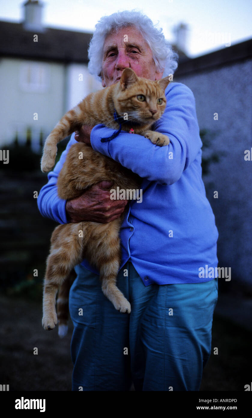 Elderly woman holding her pet cat hires stock photography and images
