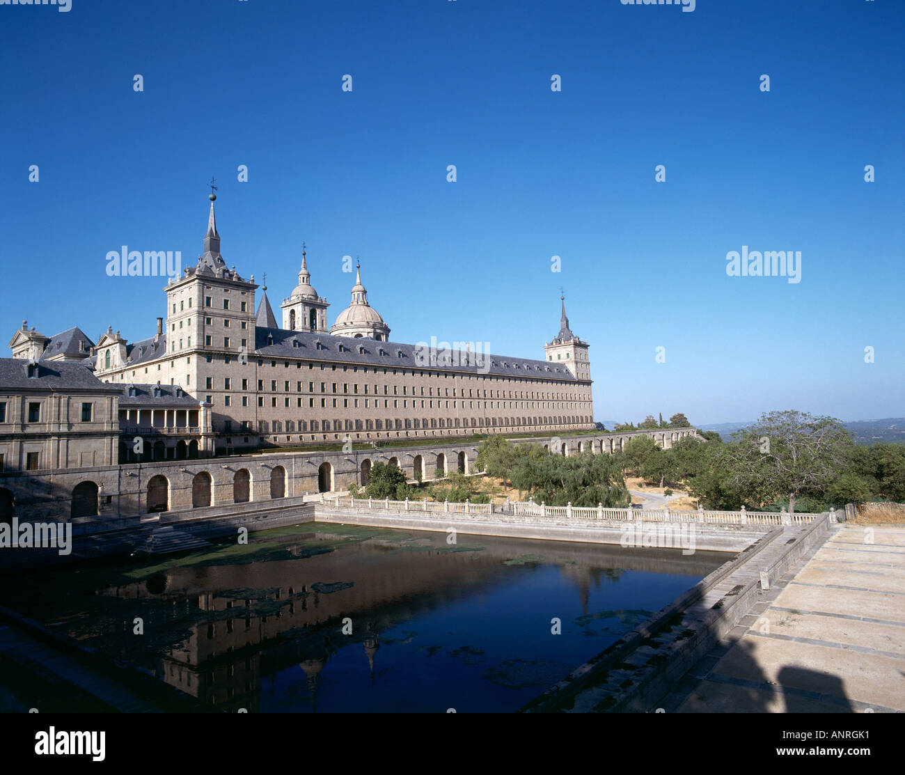 The facade and some of the 2 673 windows of the Palacio de San Lorenzo el Real de El Escorial built of granite in the 16th century on a monumental scale by Felipe II as a combination monastery palace mausoleum Stock Photo