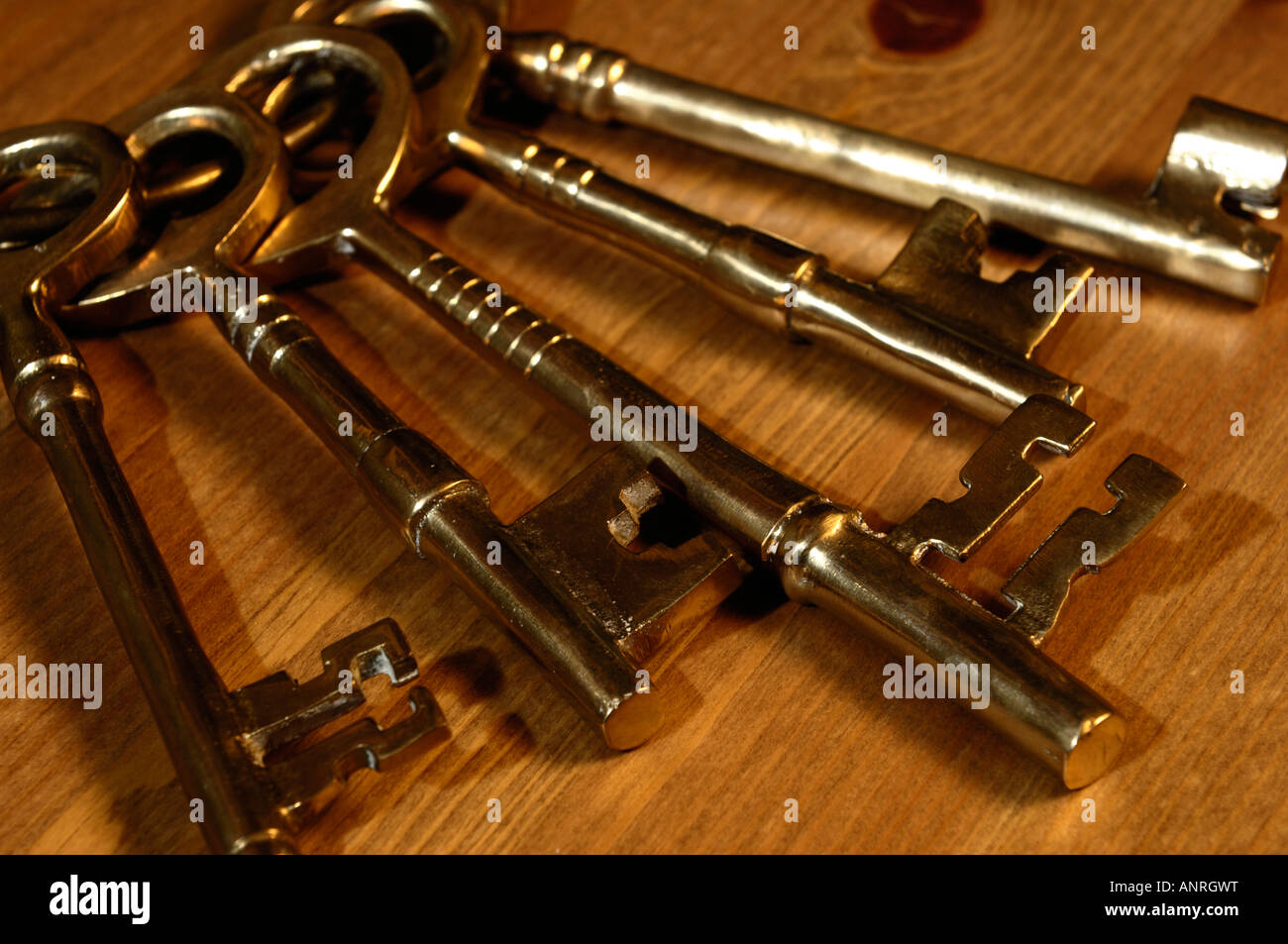 Bunch of old brass skeleton keys on a wooden table Stock Photo