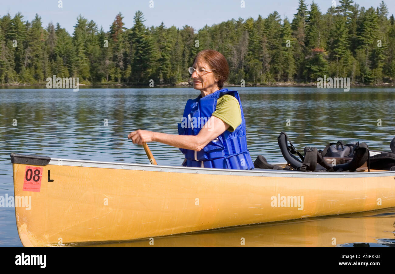 Quetico Provincial Park Ontario Sue Welch 70 paddles a canoe during a