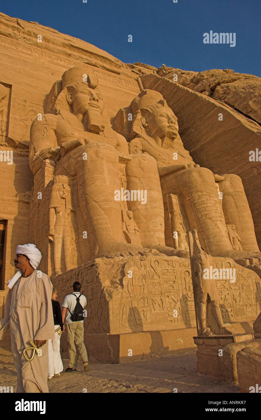 The might statues of Ramases II still watch the dawn at Abu Simbel Stock Photo