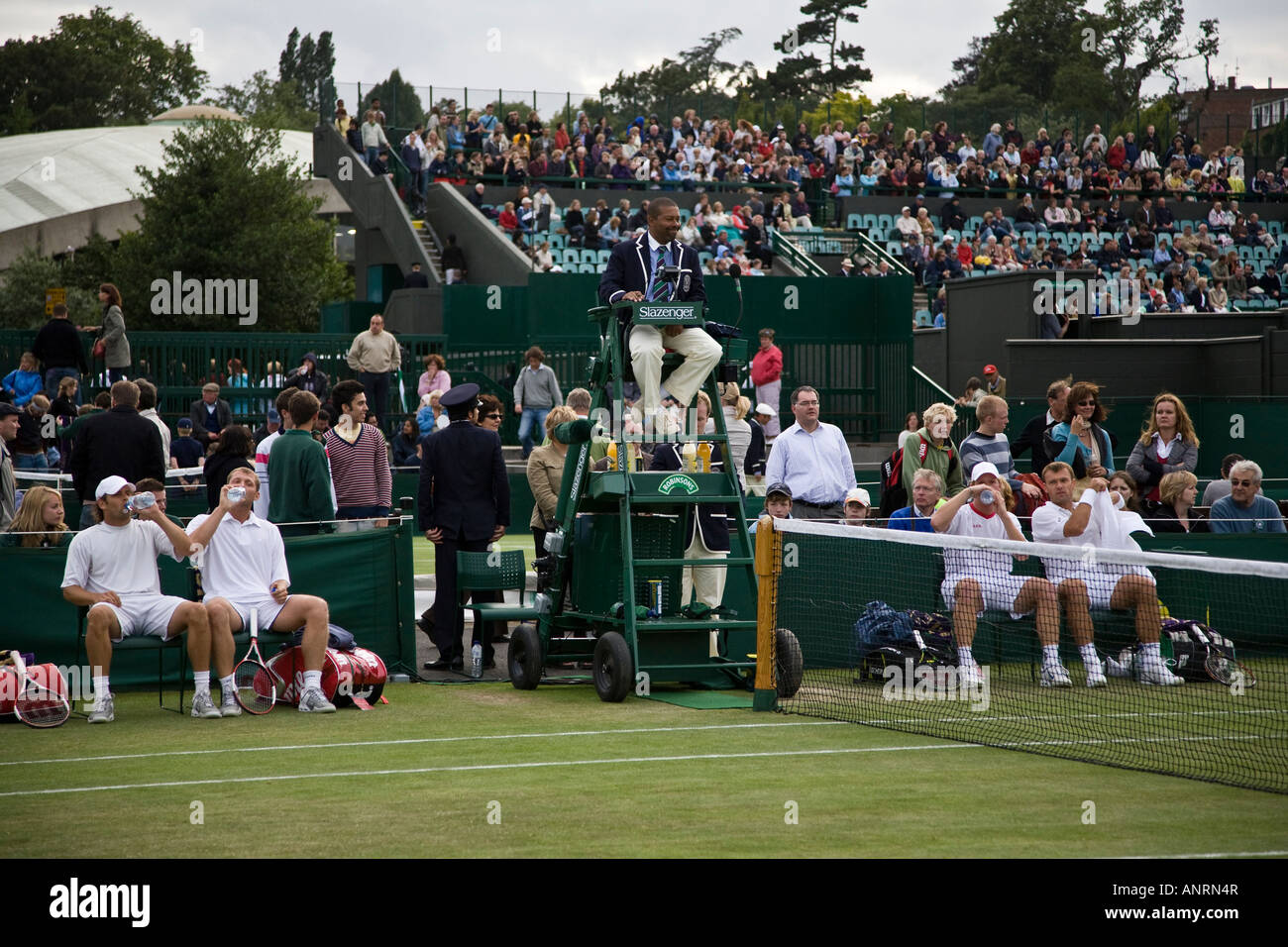 Jordan Kerr, Tomas Cibulec, Lukas Dlouhy, Pavel Vizner take a break during a gentleman's doubles match, Wimbledon, London. Stock Photo