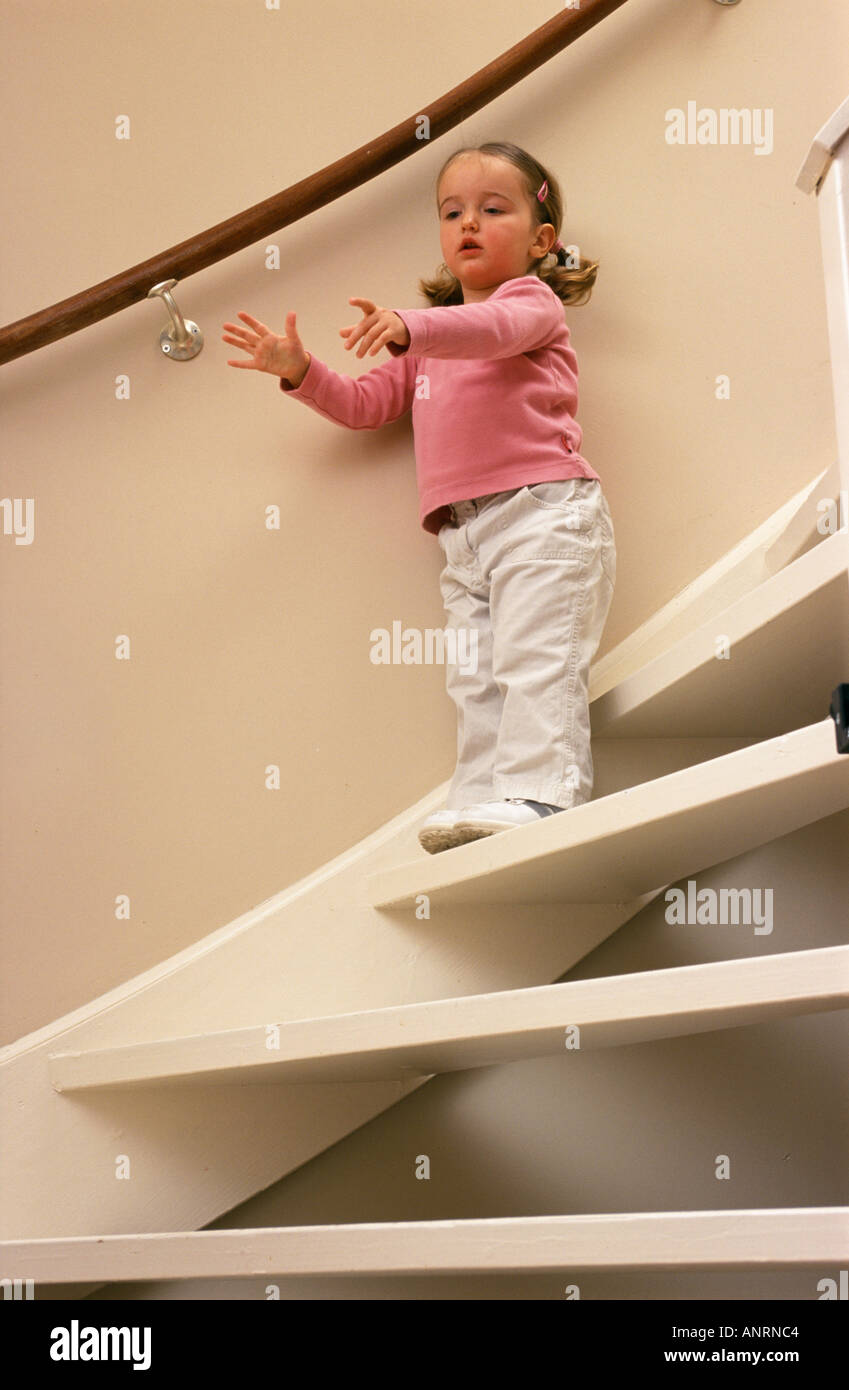 Little girl on a staircase Stock Photo - Alamy