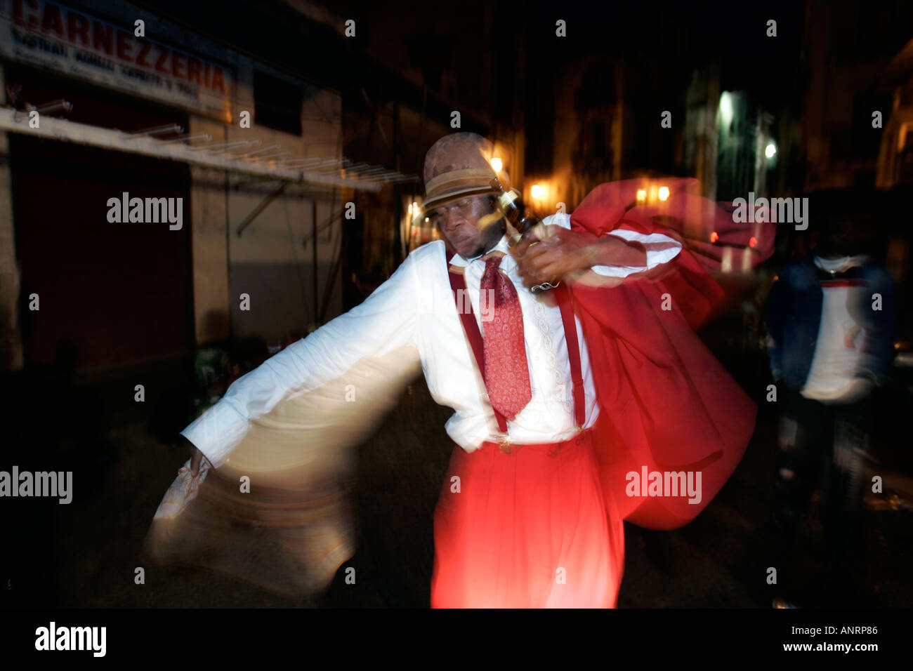 Man dancing in the street at night Ballaro Palermo Sicily Italy Stock Photo
