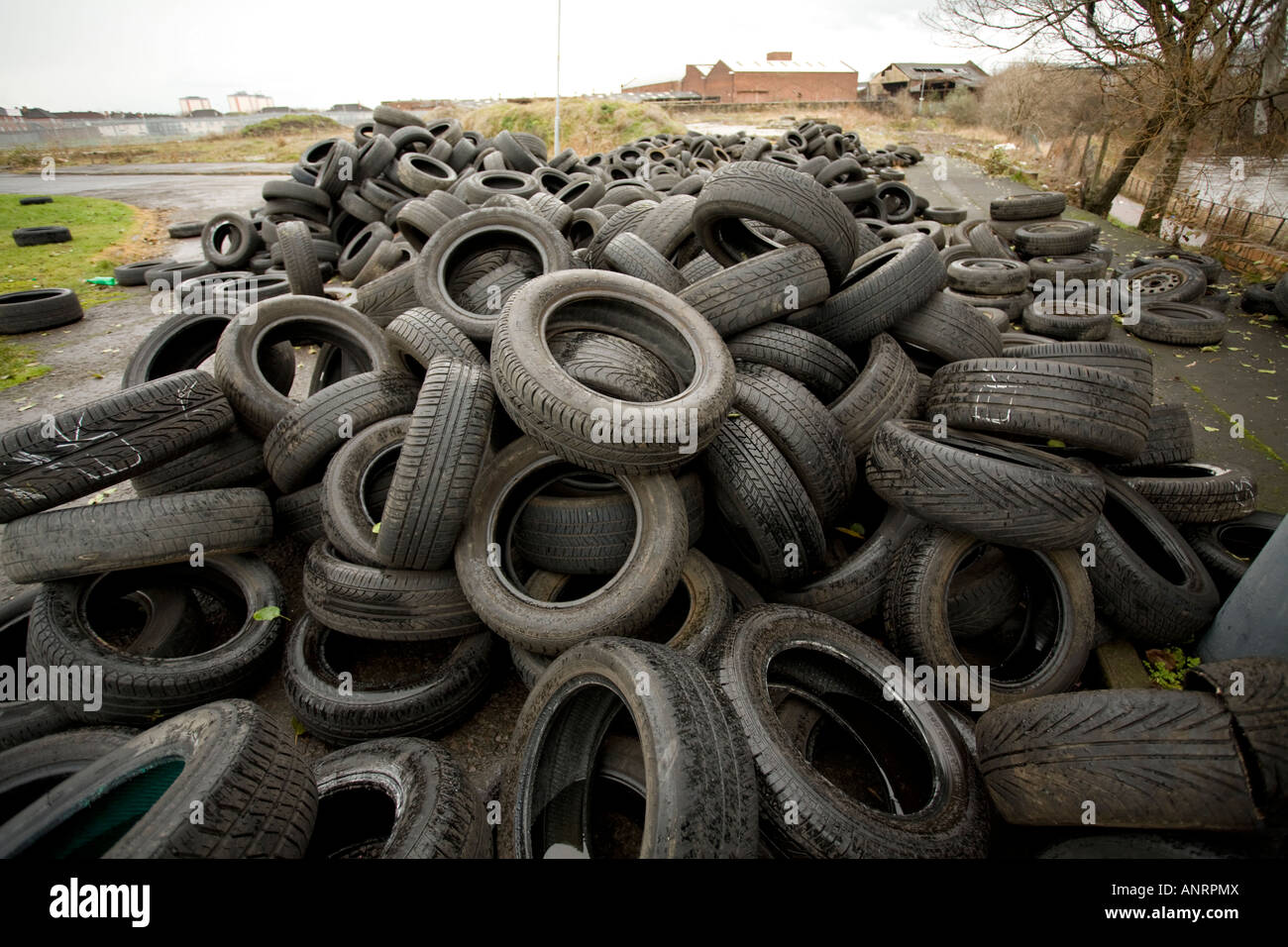 Fly tipping illegal dumping of tyres along the banks of the Clyde in