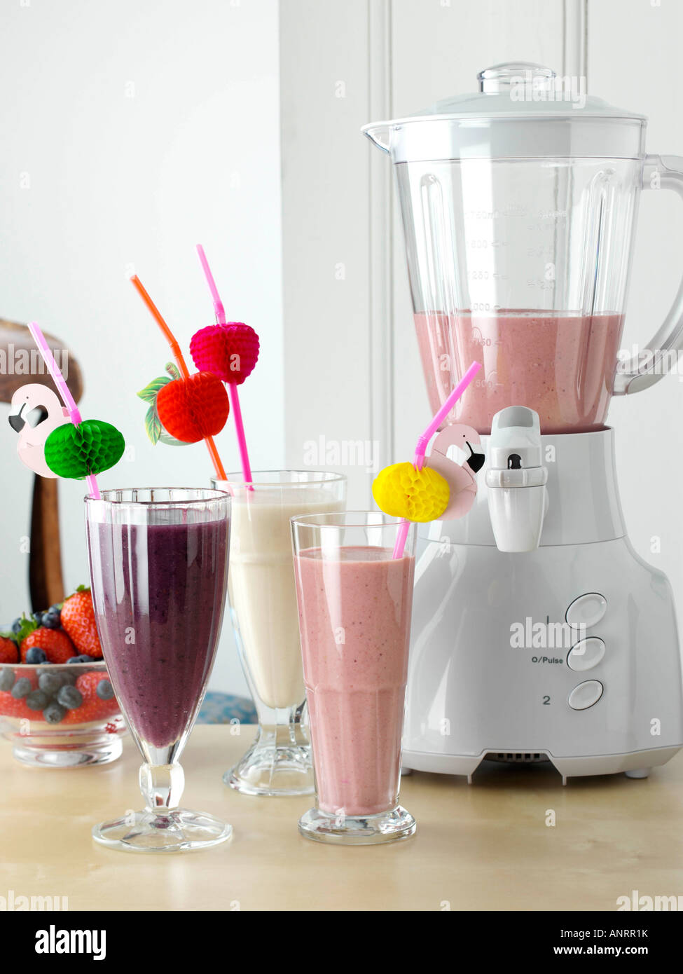 Blender and banana strawberry and blueberry mango smoothies healthy fresh fruit vegetarian editorial food Stock Photo