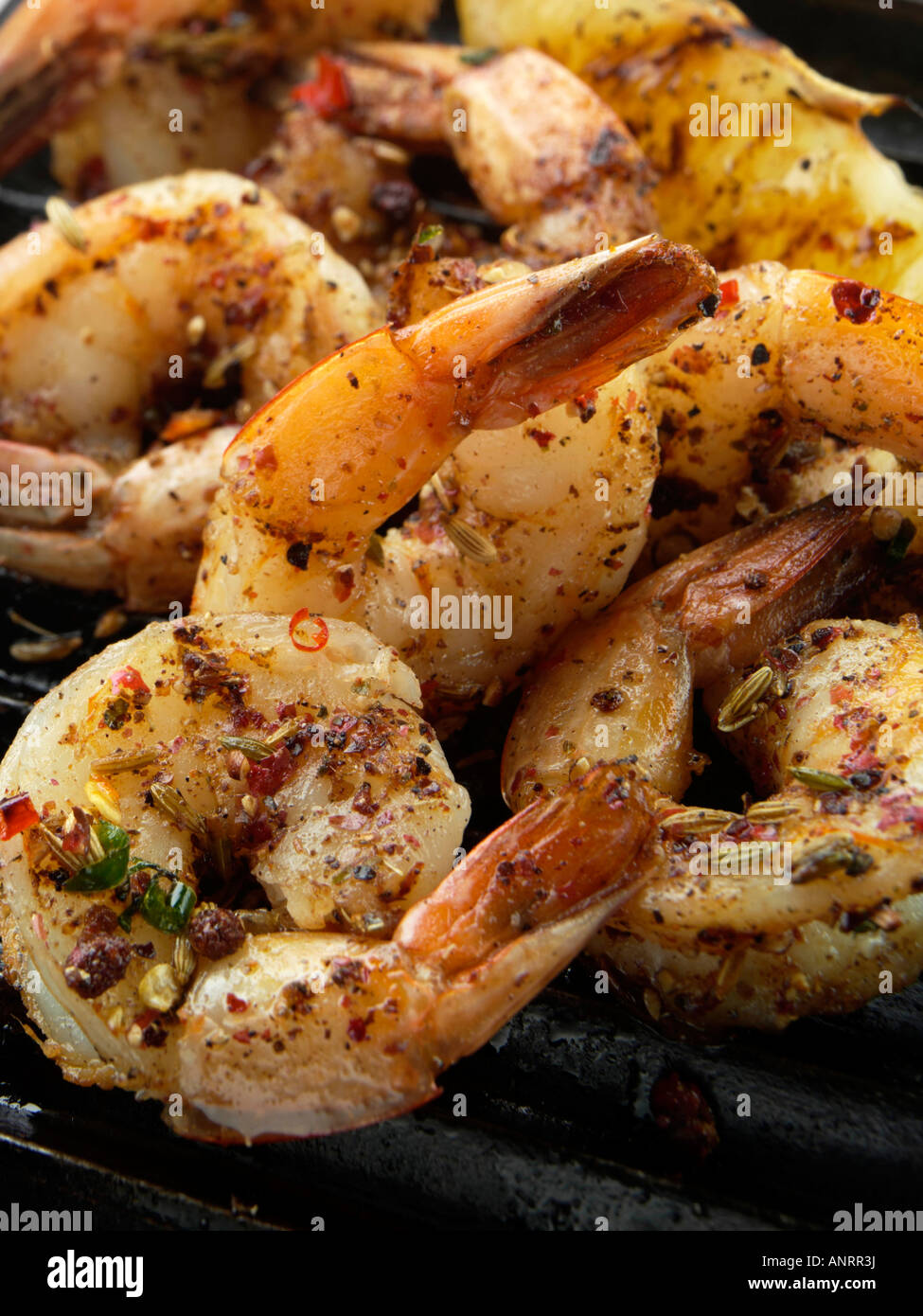 Tail on prawns on a griddle gourmet editorial food Stock Photo