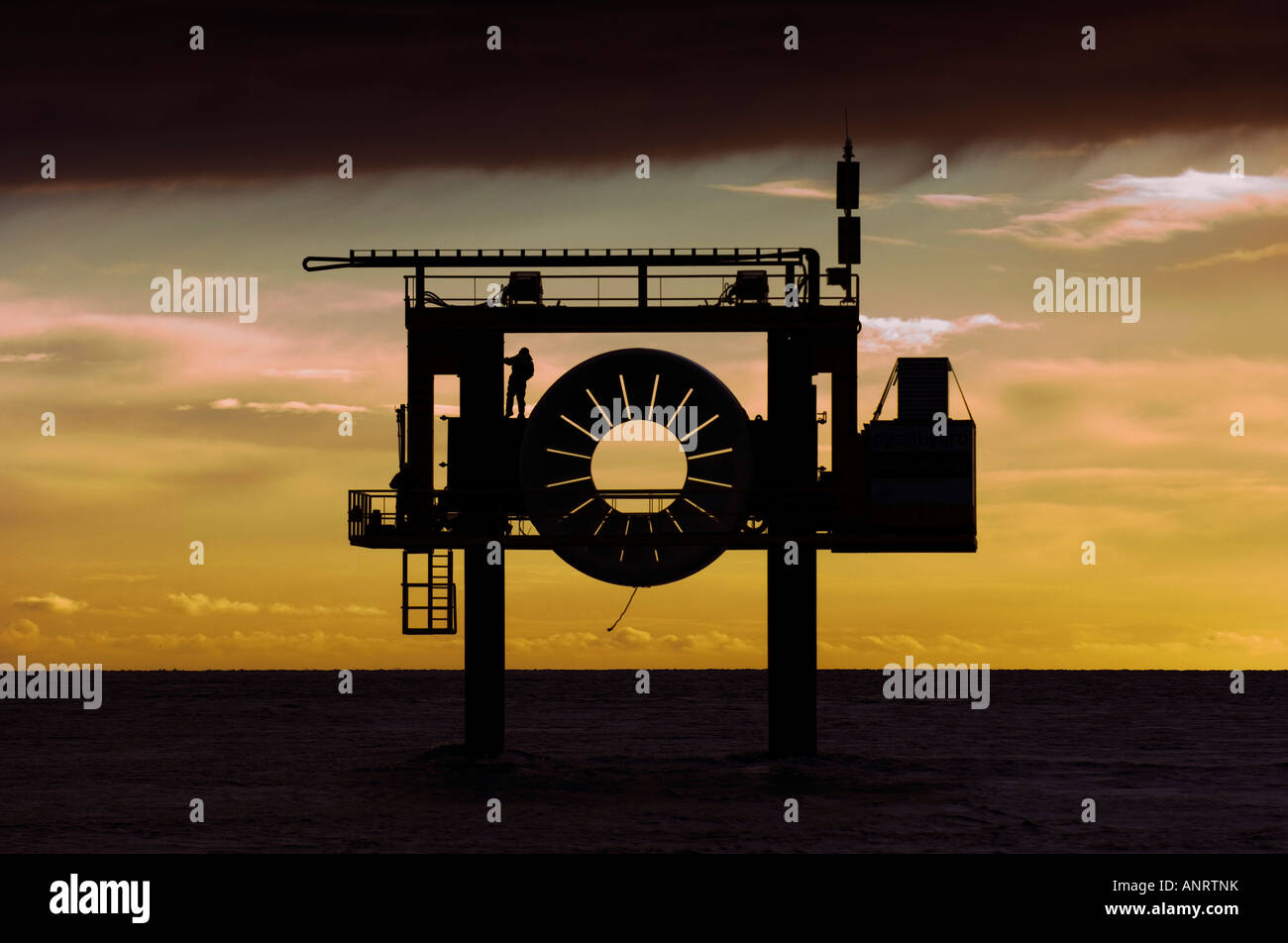 Tidal turbine power generator at sunset Stock Photo