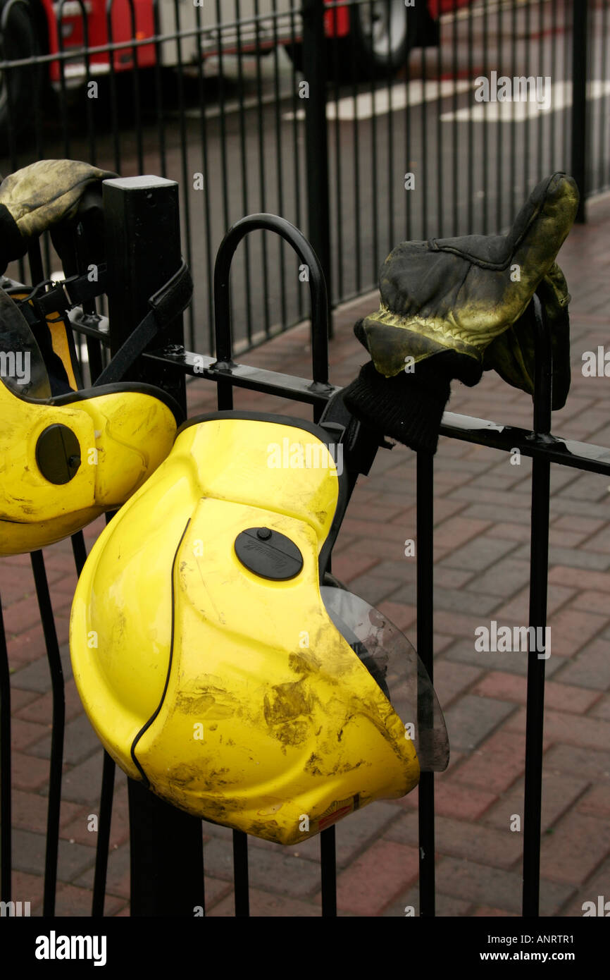 Firemen's helmets and gloves on railings Stock Photo Alamy