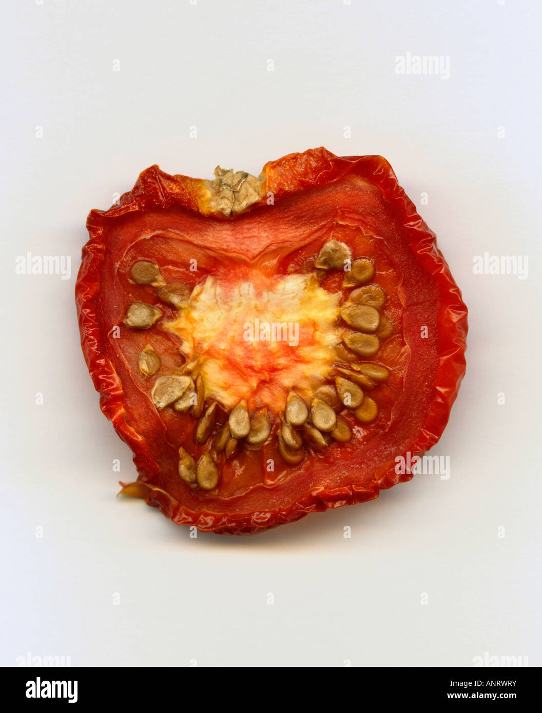 Dried red tomato on plain background, close-up Stock Photo