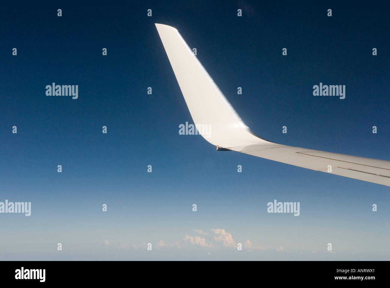 Wing of an airplane deep blue sky clouds above the clouds 2006 2000s HOMER SYKES Stock Photo