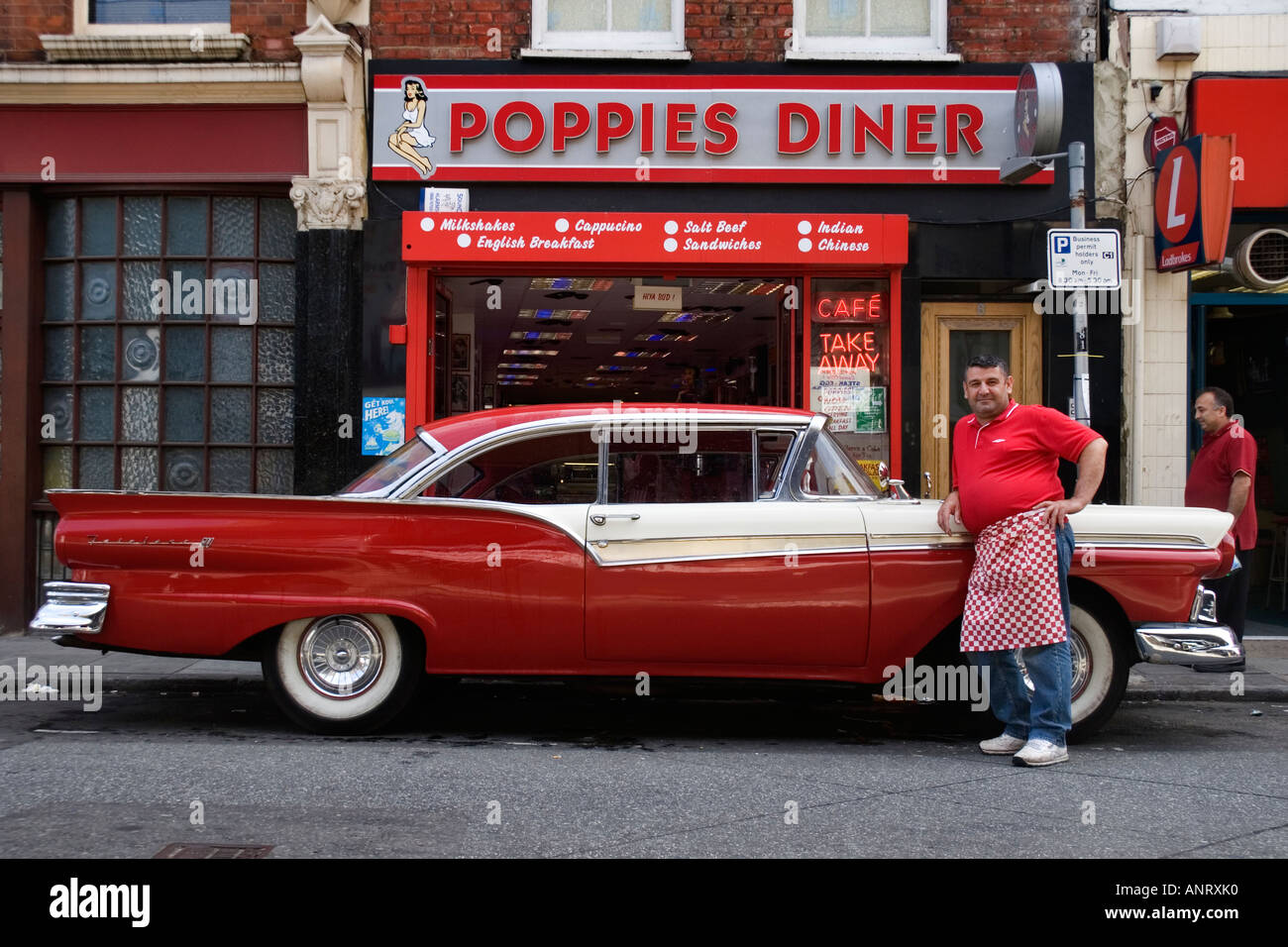 An Old Red American Classic Car Outside A Diner With The Chef Wearing His Red T Shirt And Red Check Apron East London Uk Stock Photo Alamy
