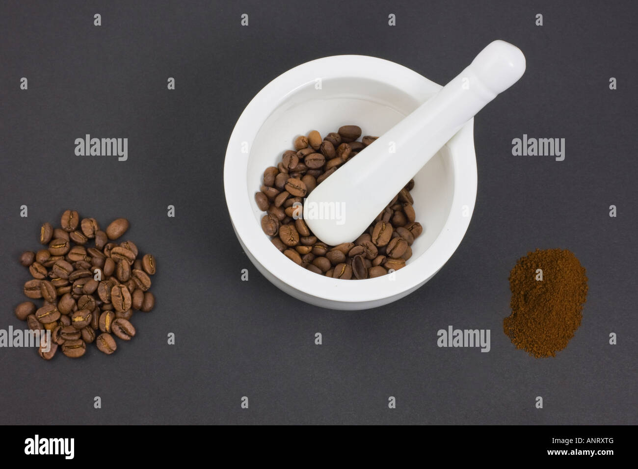 Roast coffee beans before and after grinding in mortar and pestle Stock