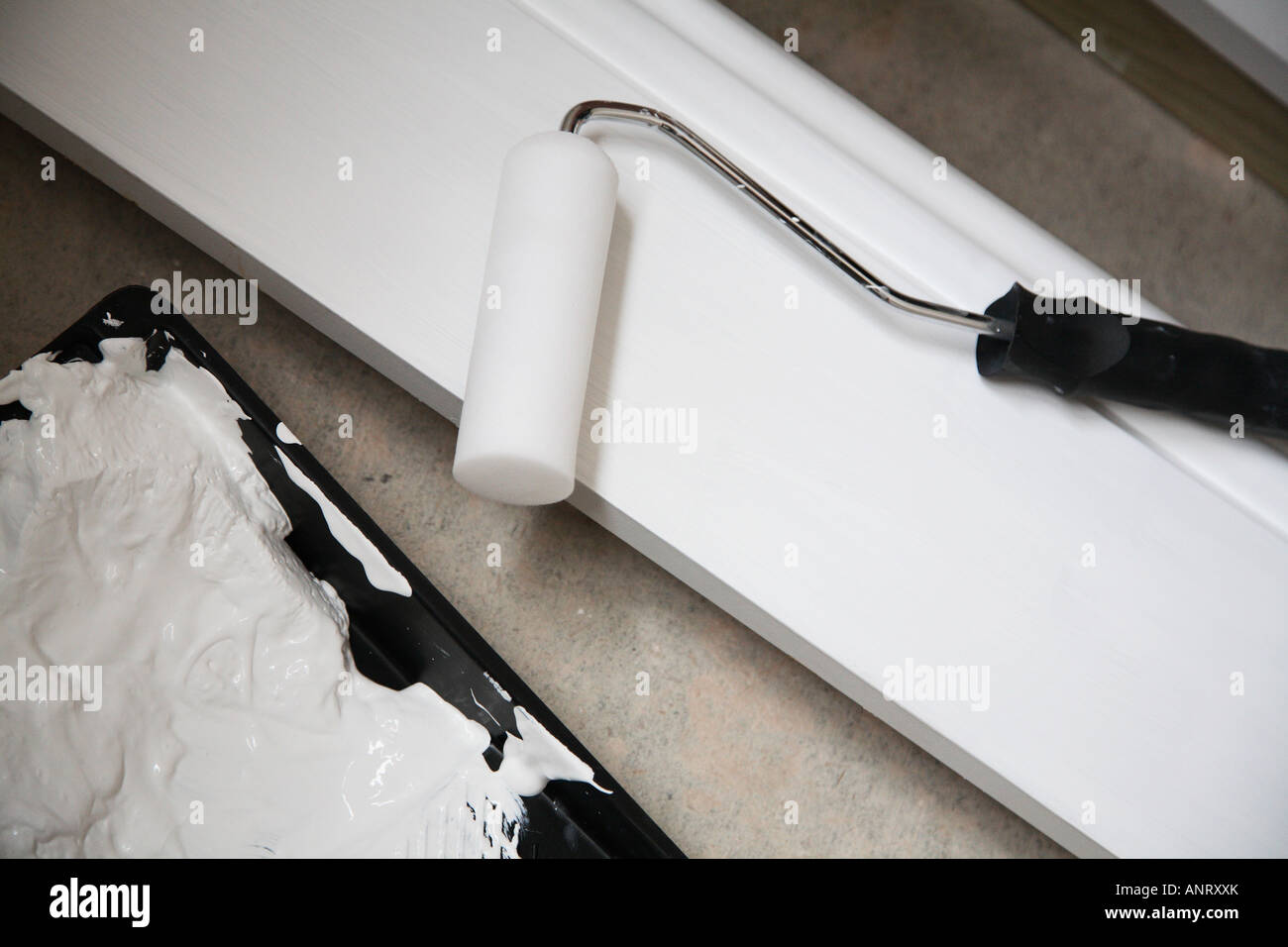 Mini Roller And Tray With White Paint On Skirting Board Stock Photo Alamy