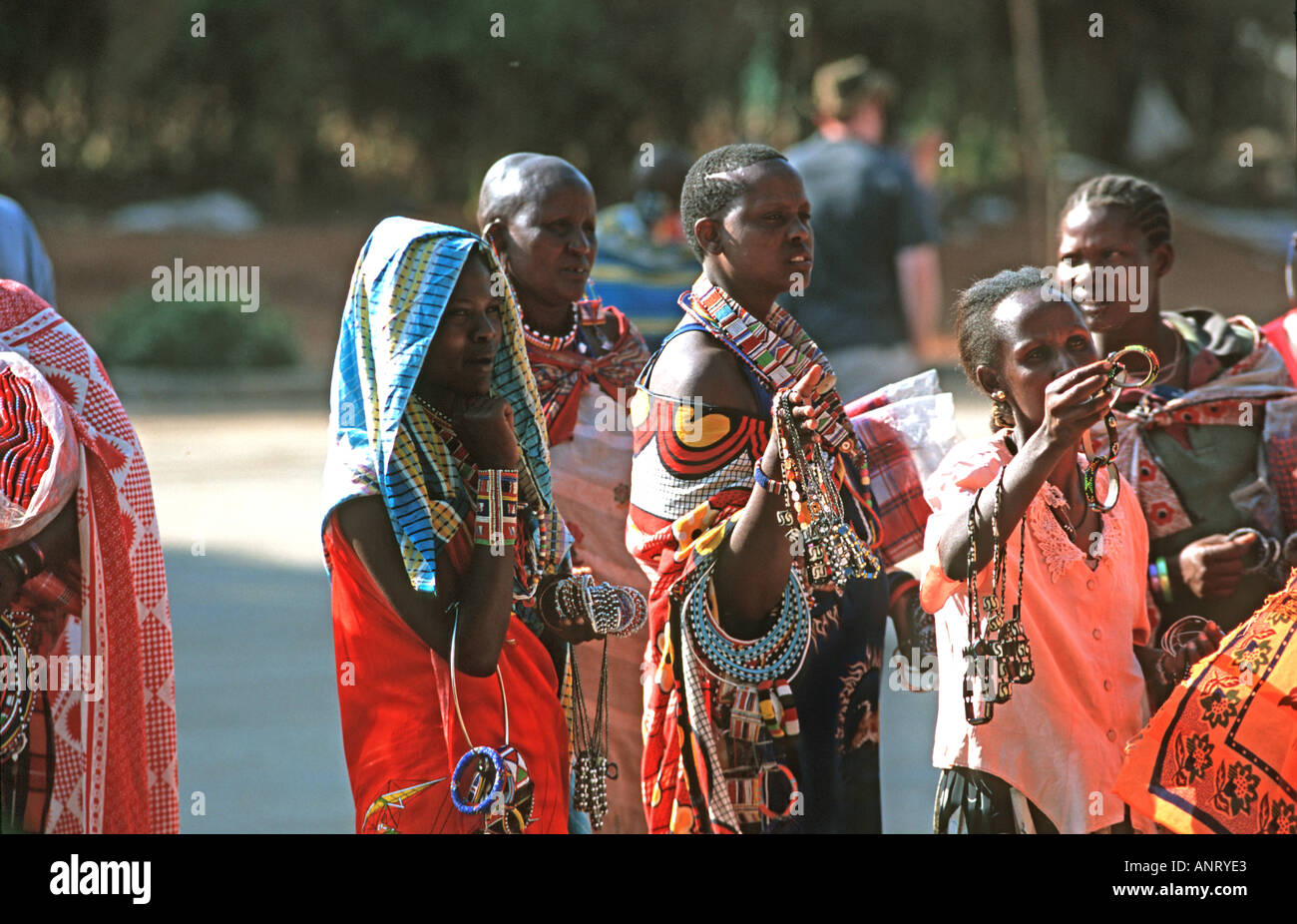 Kenyan Masai women selling handmade bracelets necklaces and other souvenirs at the border crossing from Tanzania Kenya Stock Photo