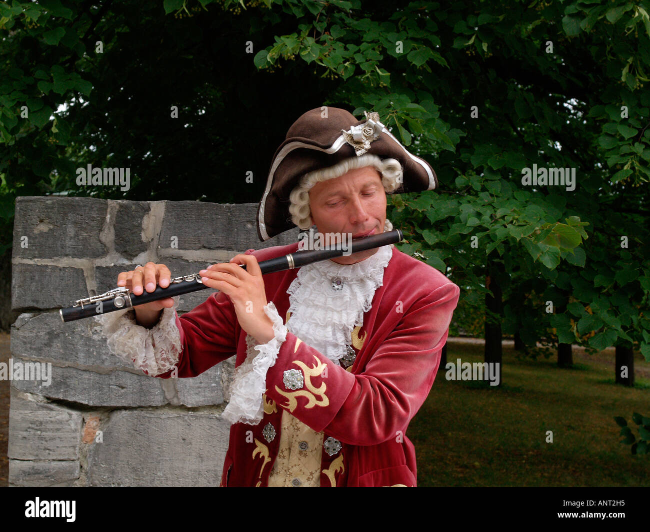 Man wearing 18th century clothes playing flute outside sans soucci Postdam Germany Stock Photo