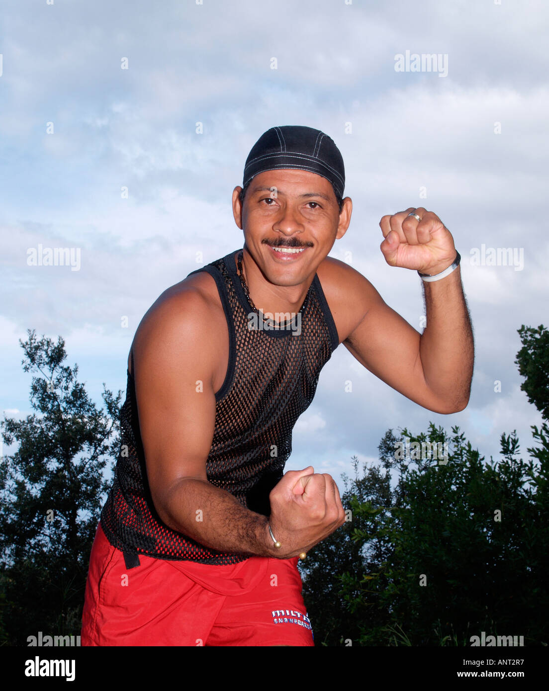 man in boxing pose wearing black string vest Stock Photo - Alamy
