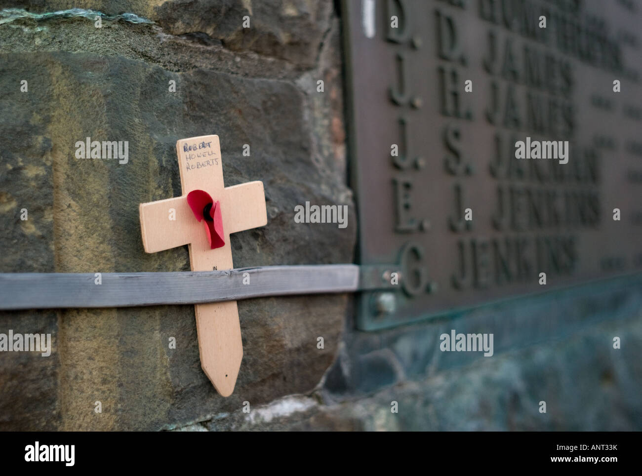 Wooden cross with name of dead soldier hand written on it. Added by hand to Aberystwyth war memorial Stock Photo