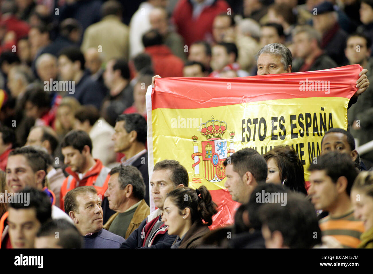 Sevilla FC fan showing a Spanish flag with a legend ...