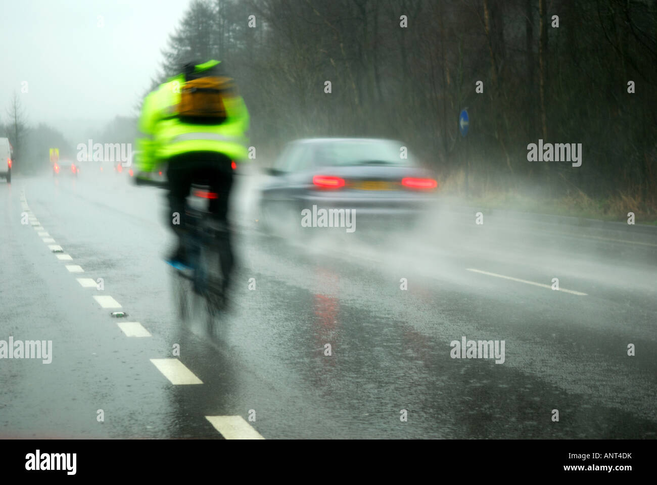 Cycling in heavy rain on road Stock Photo Alamy