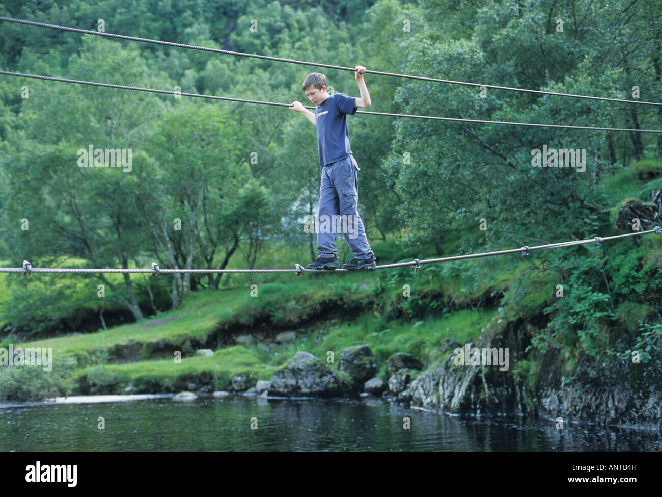 Boy on wire rope bridge Glen Nevis Scotland Stock Photo Alamy