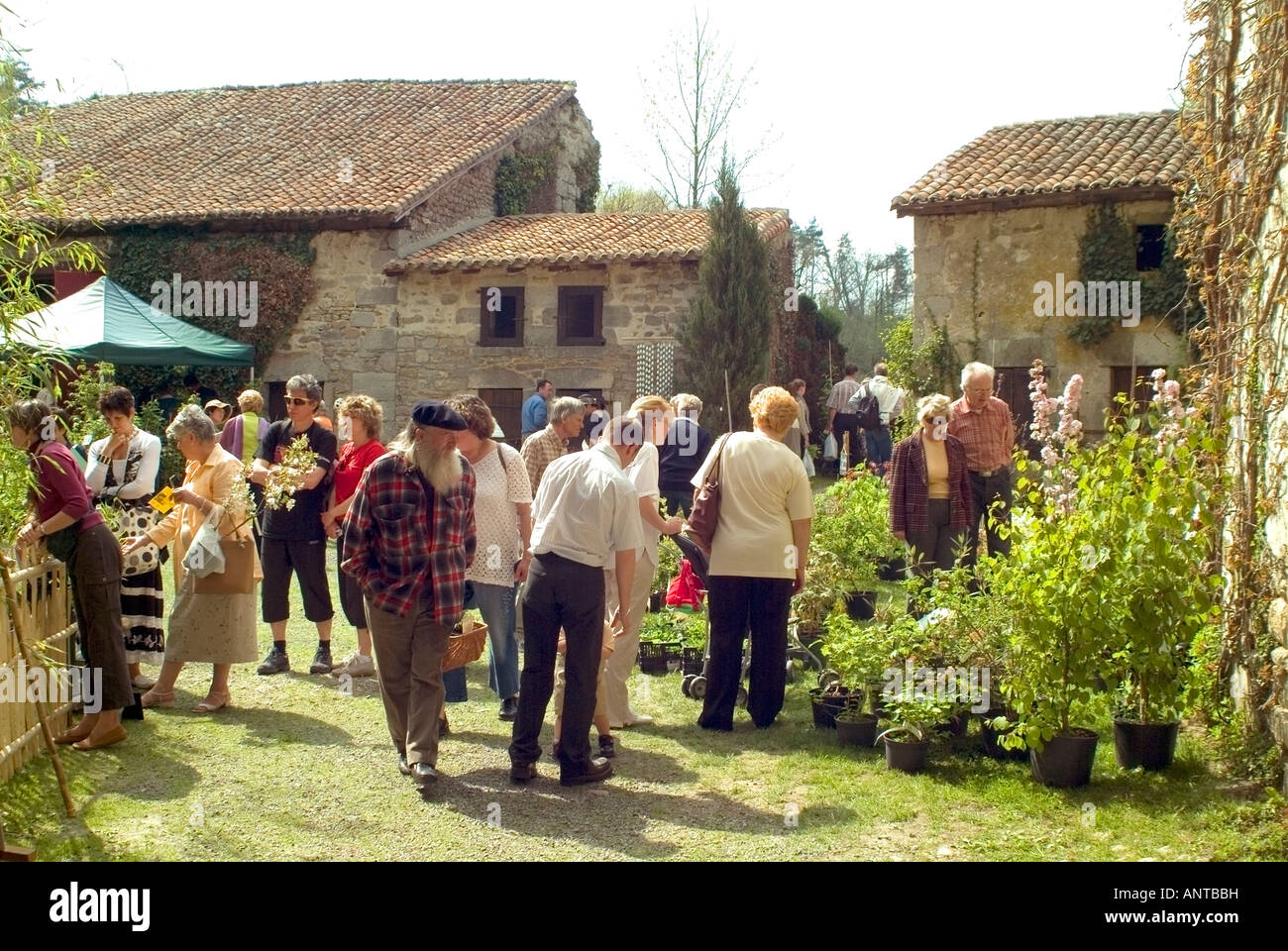 people enjoying looking & buying plants at a garden show in a the grounds of a chateau in central france Stock Photo