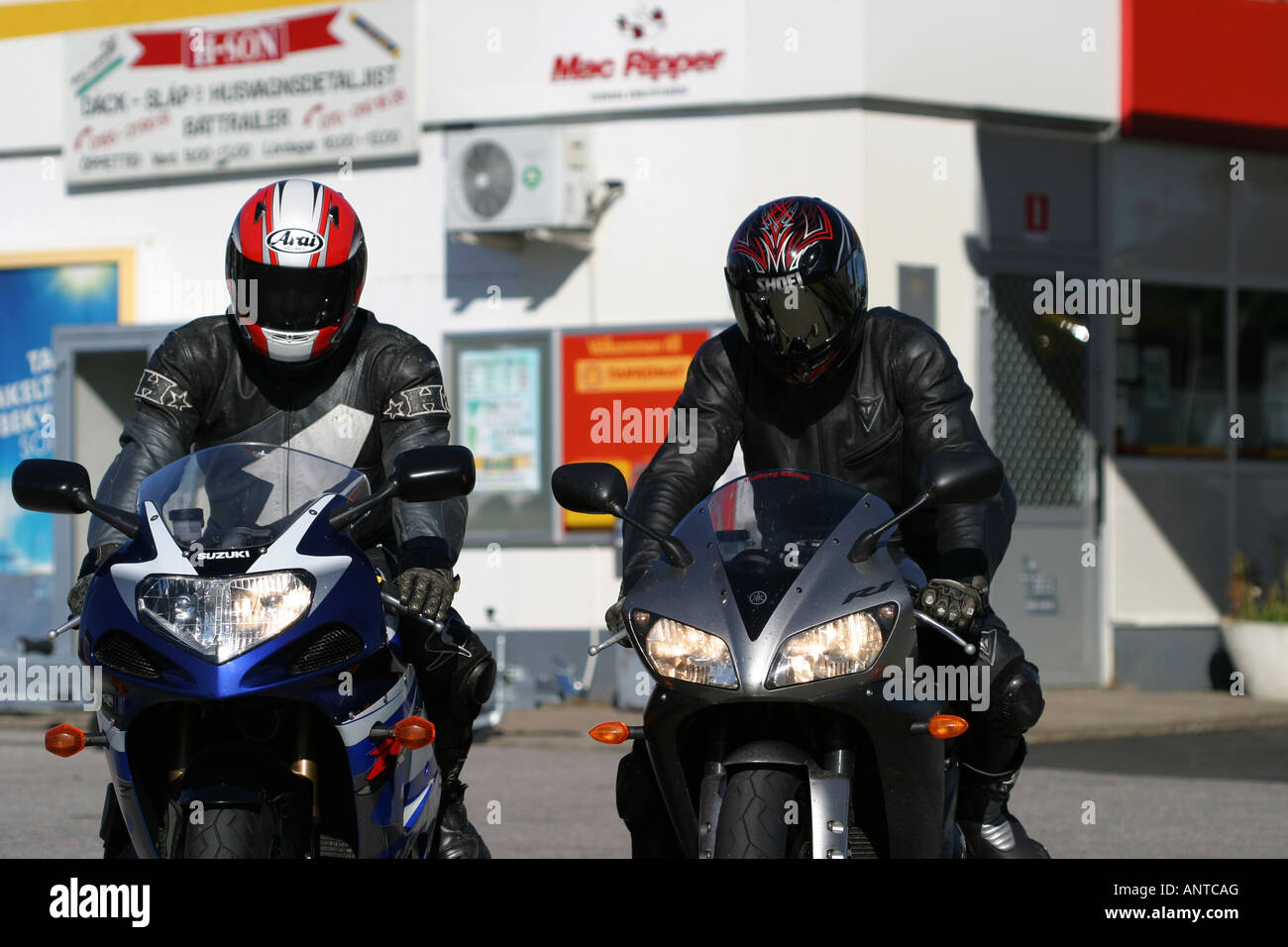 Two superbikes rider in front off a petrol station Stock Photo - Alamy