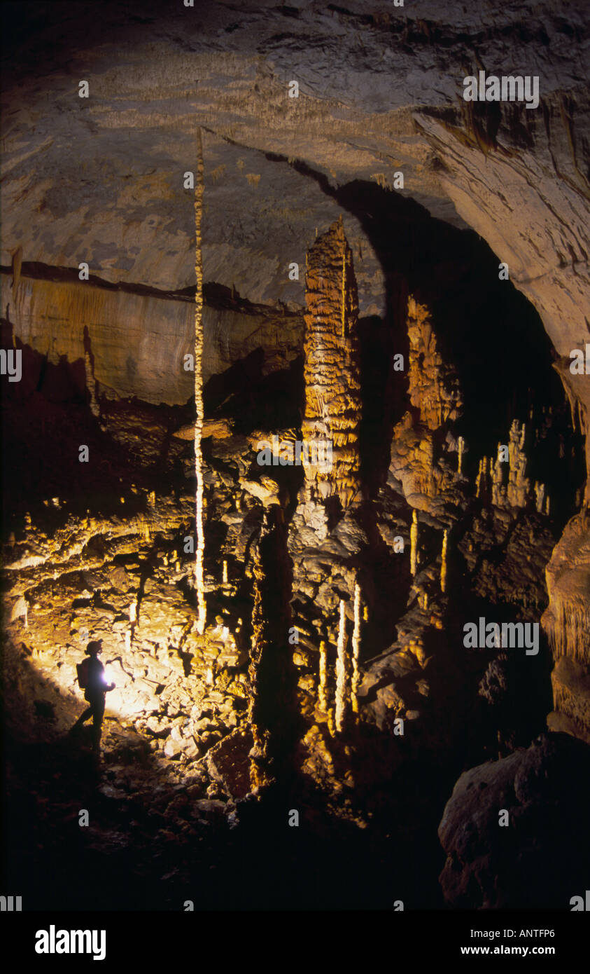 Caver with impressive stalagmites in a cave in Doubs France Stock Photo