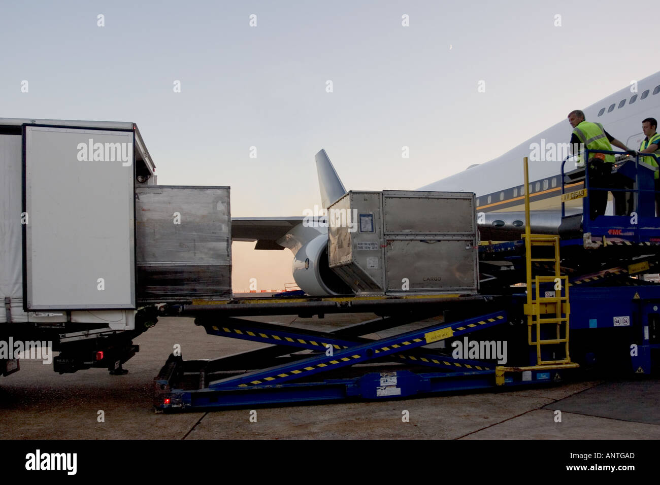Loading cargo into aeroplane at airport UK Stock Photo