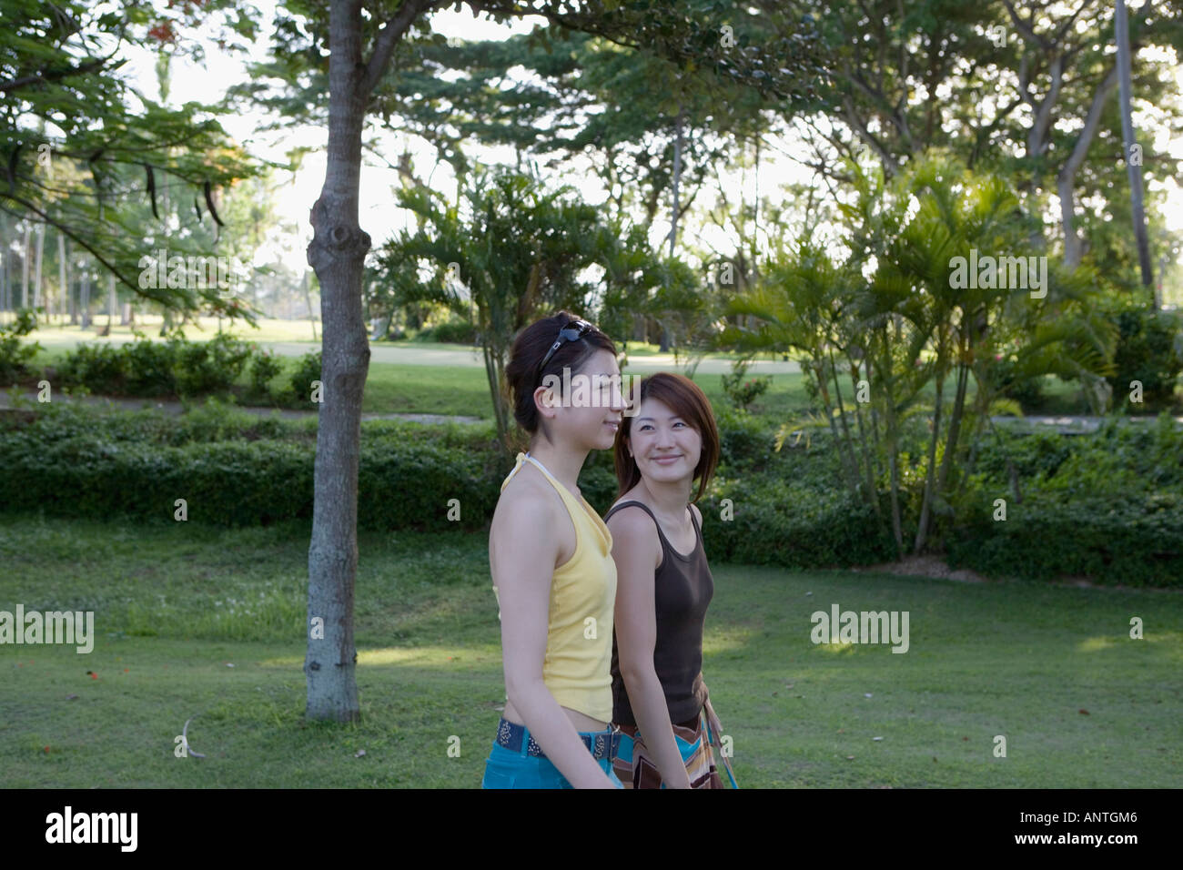 Two young women walking Stock Photo - Alamy