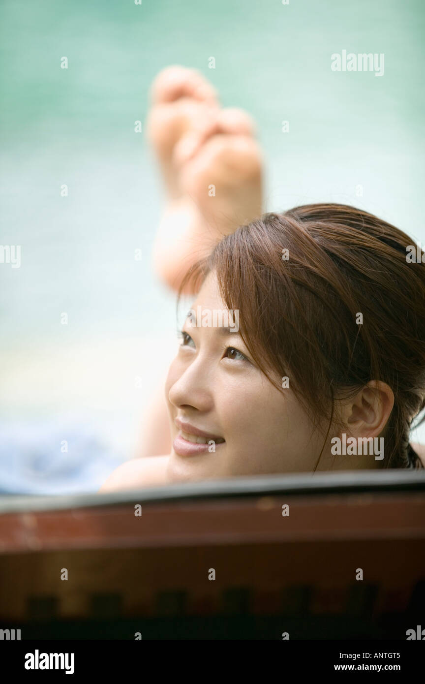 Young woman on deck chair Stock Photo