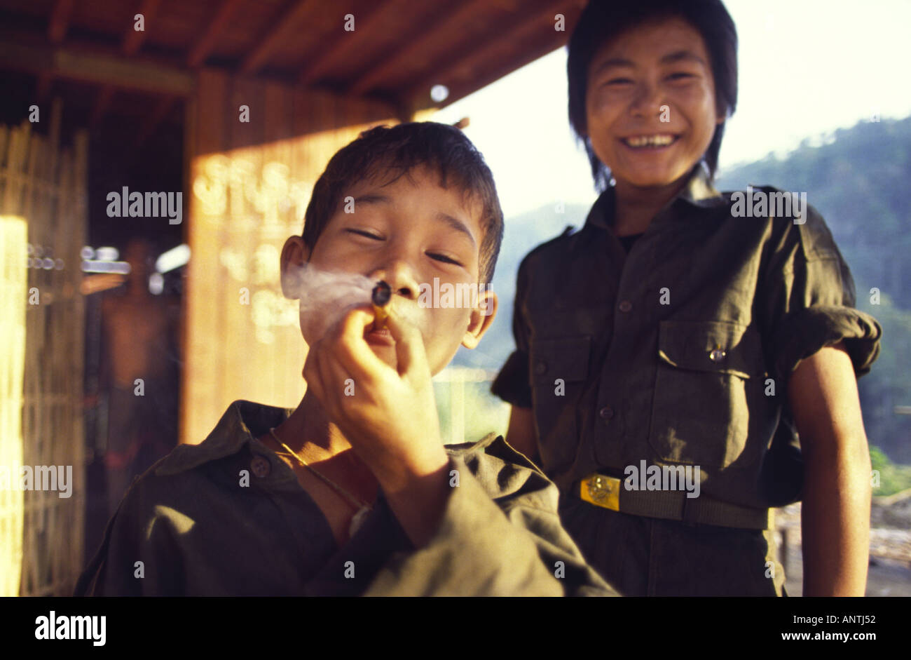Karen boy soldier smoking a Cheroot Kawtholei Burma Stock Photo