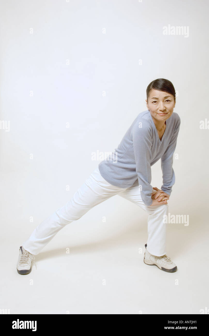 Middle age woman stretching legs hi-res stock photography and images ...