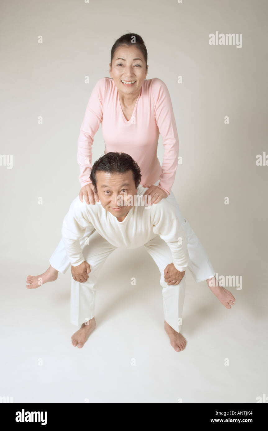 Mature man giving mature woman piggyback Stock Photo - Alamy