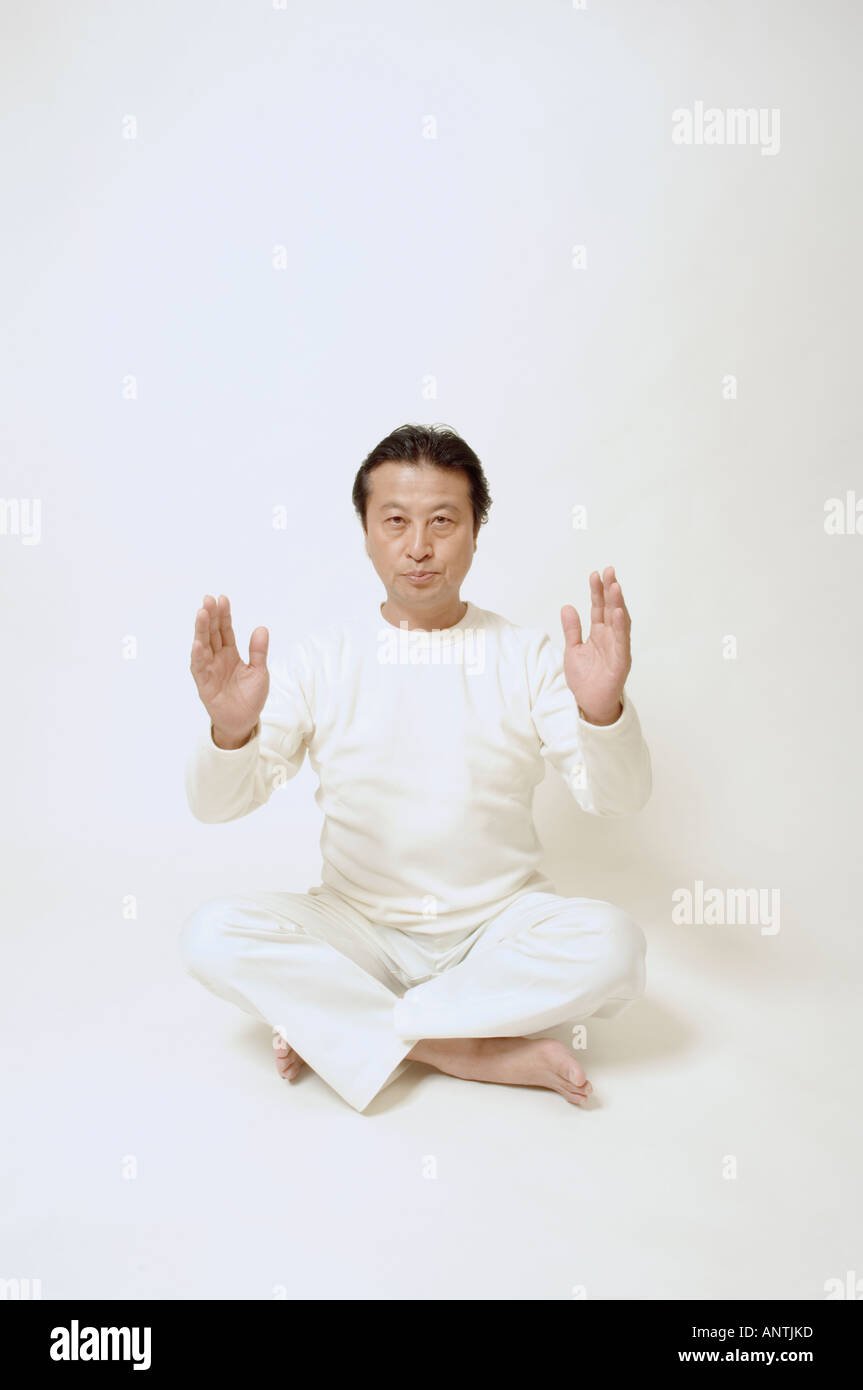 Mature man sitting on floor Stock Photo - Alamy