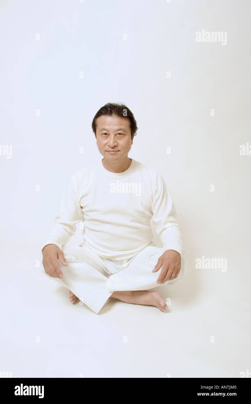 Mature man sitting on floor Stock Photo - Alamy