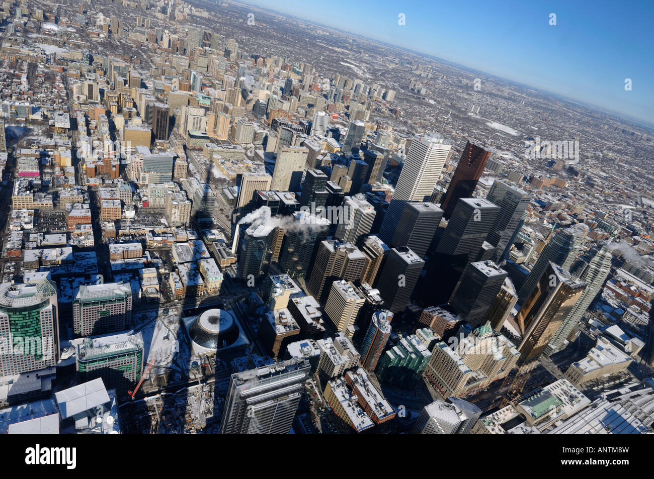 Tilted horizon view of downtown high-rises and Toronto Northeast in winter with shadow of CN Tower Stock Photo