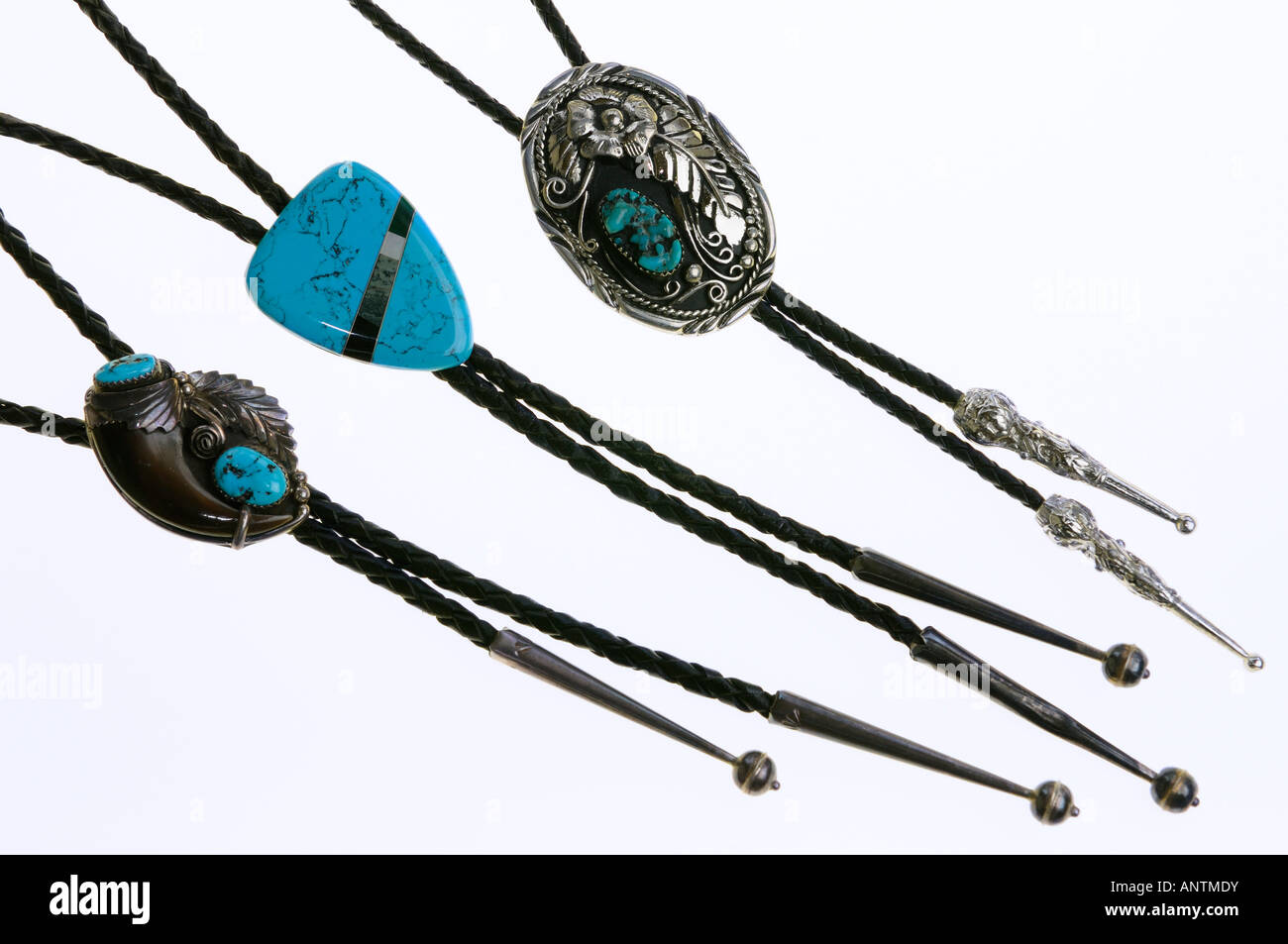 Three bolo ties with turquoise stone inlay on white background Stock Photo