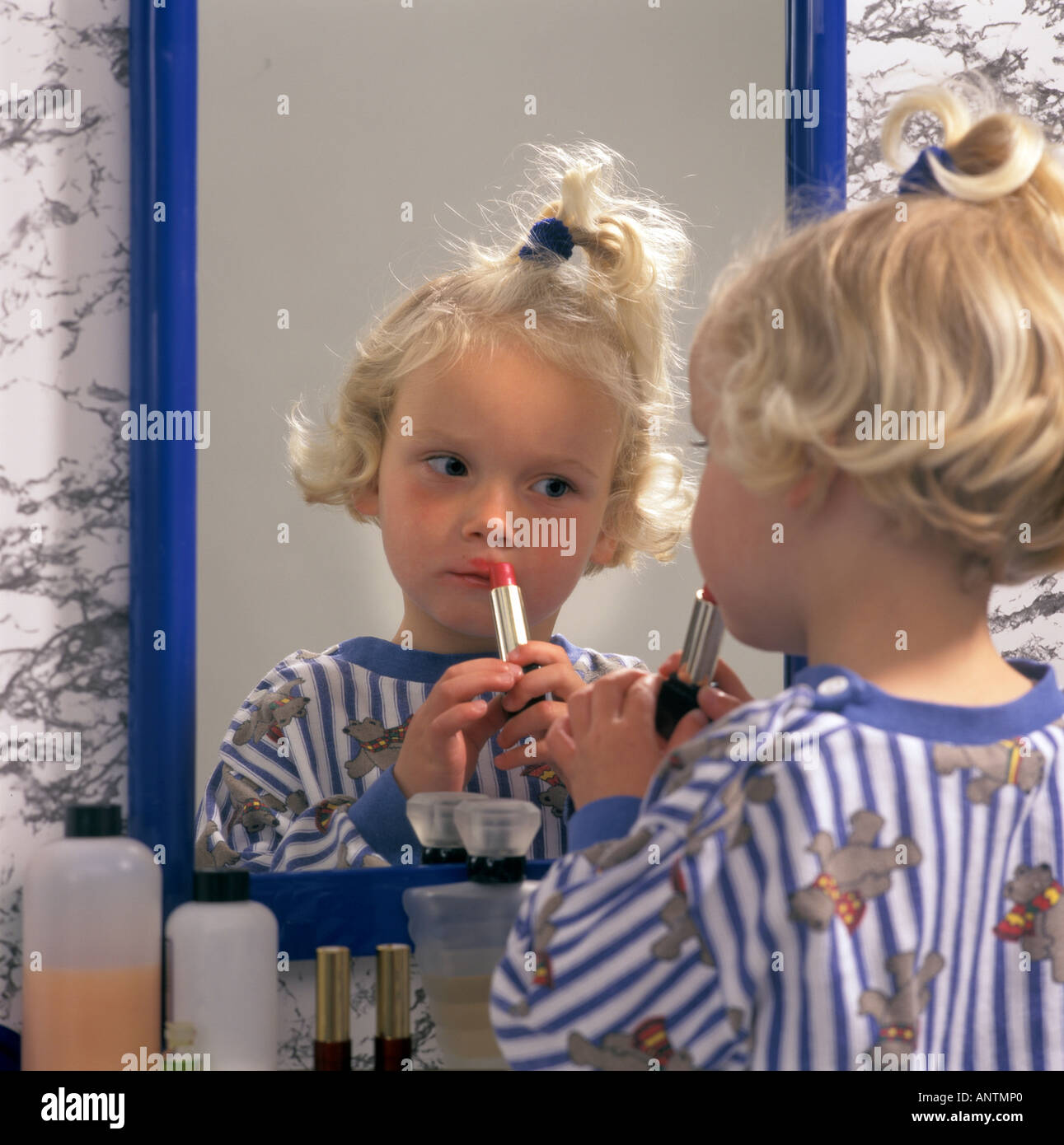 Little girl putting lipstick on hires stock photography and images Alamy