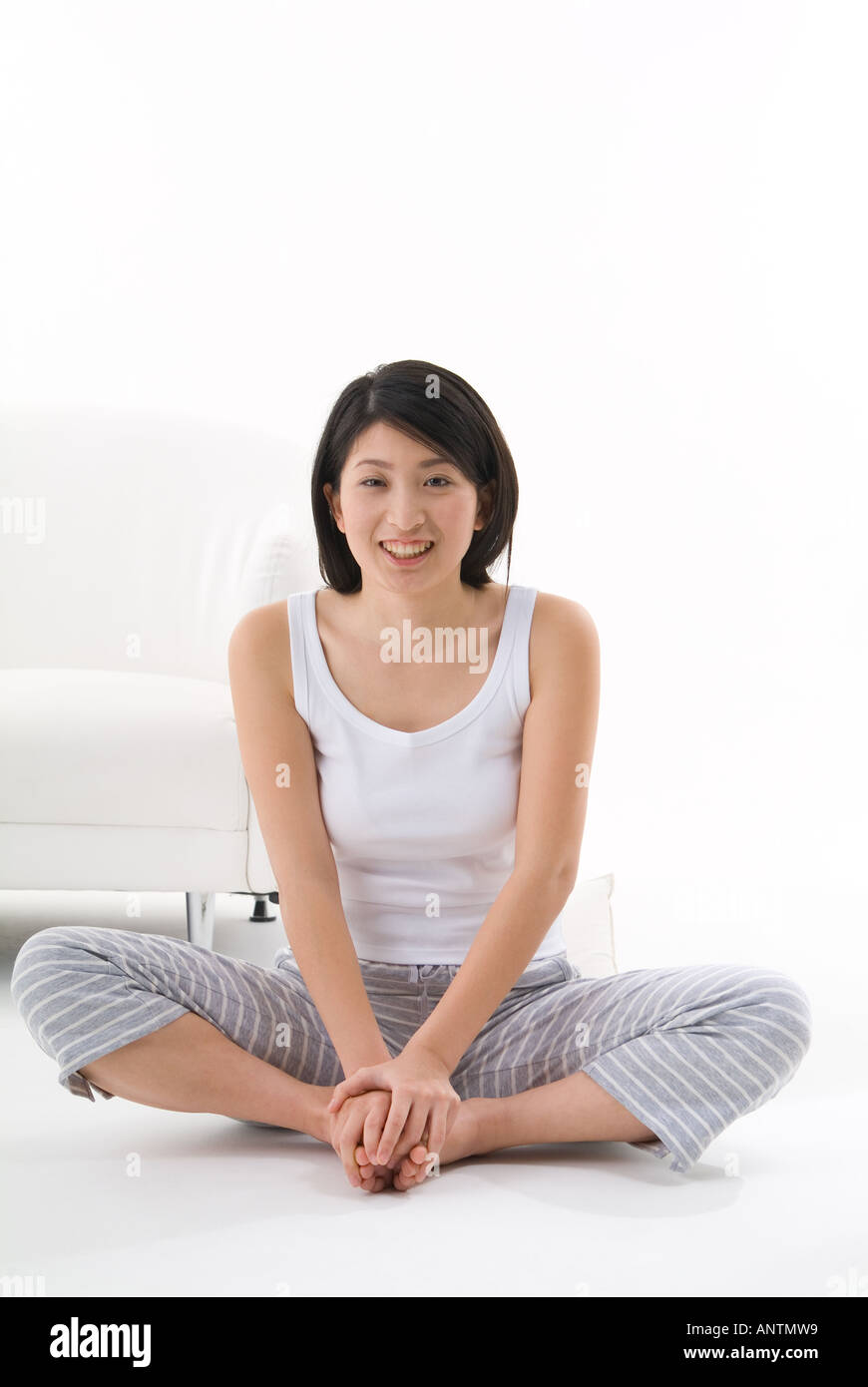 Young woman sitting on floor Stock Photo - Alamy