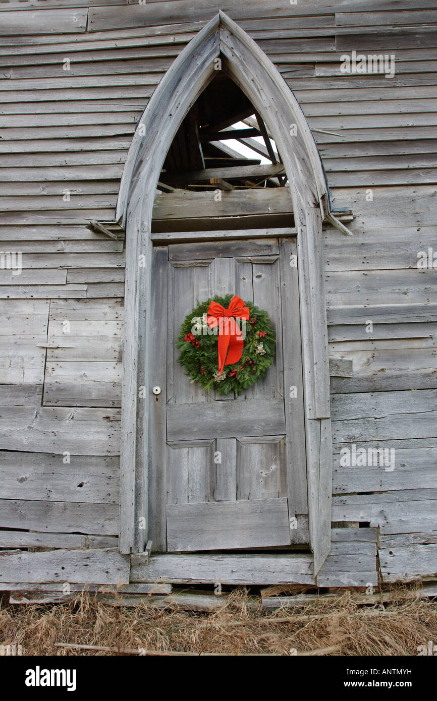 Christmas wreath on abandoned rural church Stock Photo