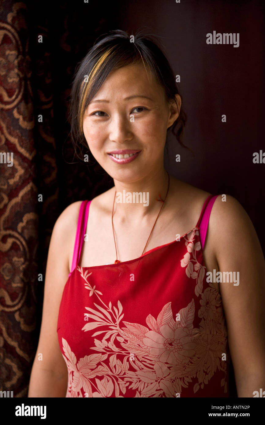 Beautiful asian oriental Chinese woman in red top dress smiling looking