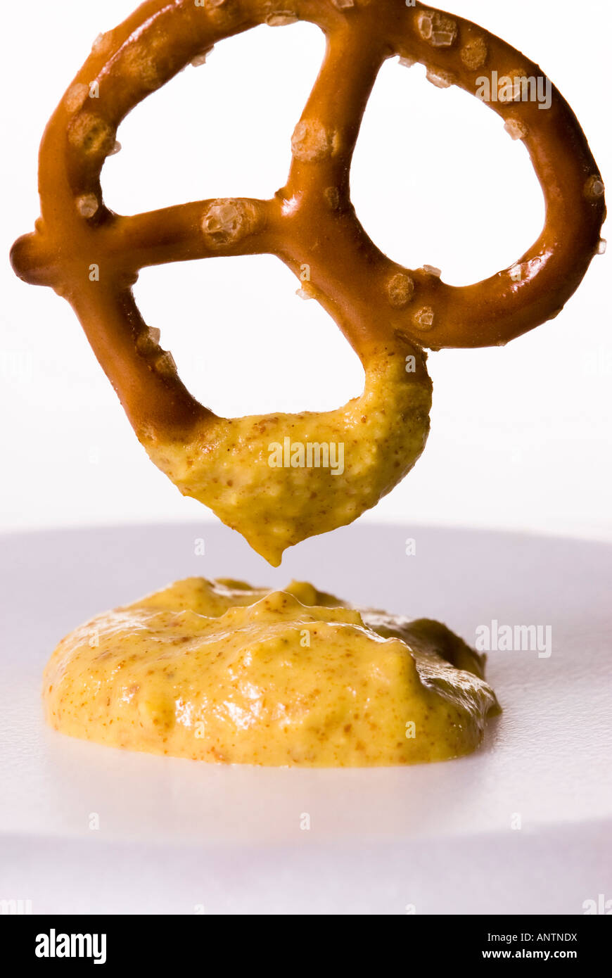 a baked twisted pretzel with a horseradish mustard dip Stock Photo Alamy