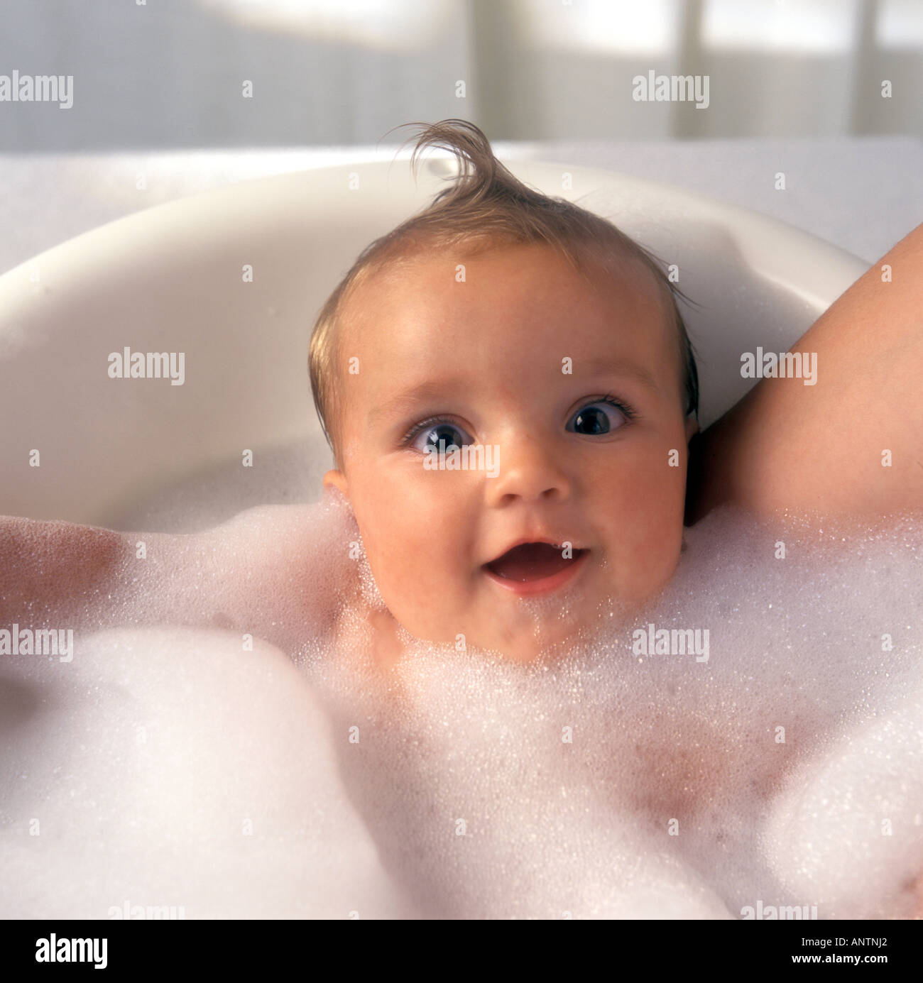 Baby in foam bath Stock Photo Alamy