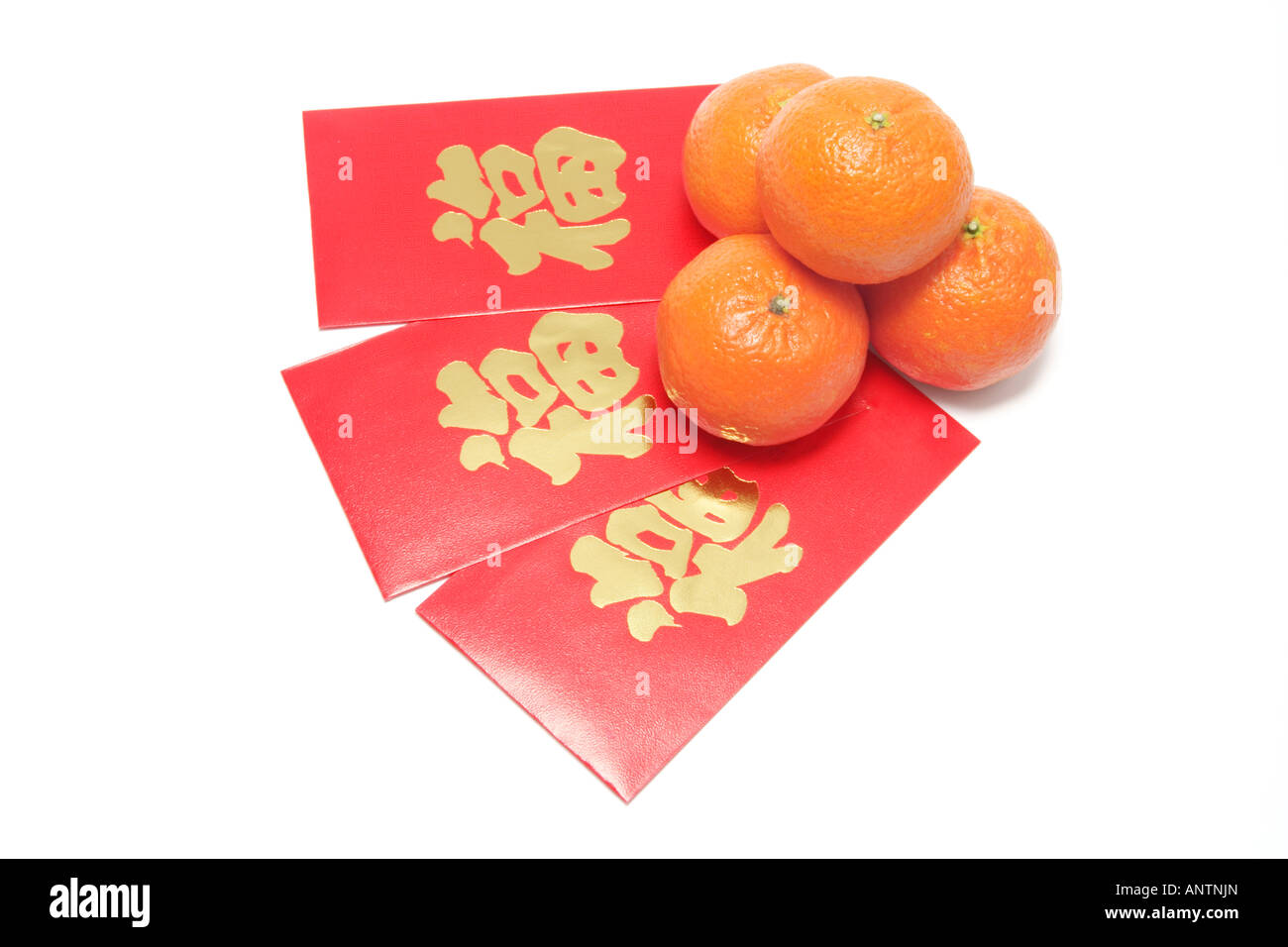 Mandarins and Red Packets Stock Photo