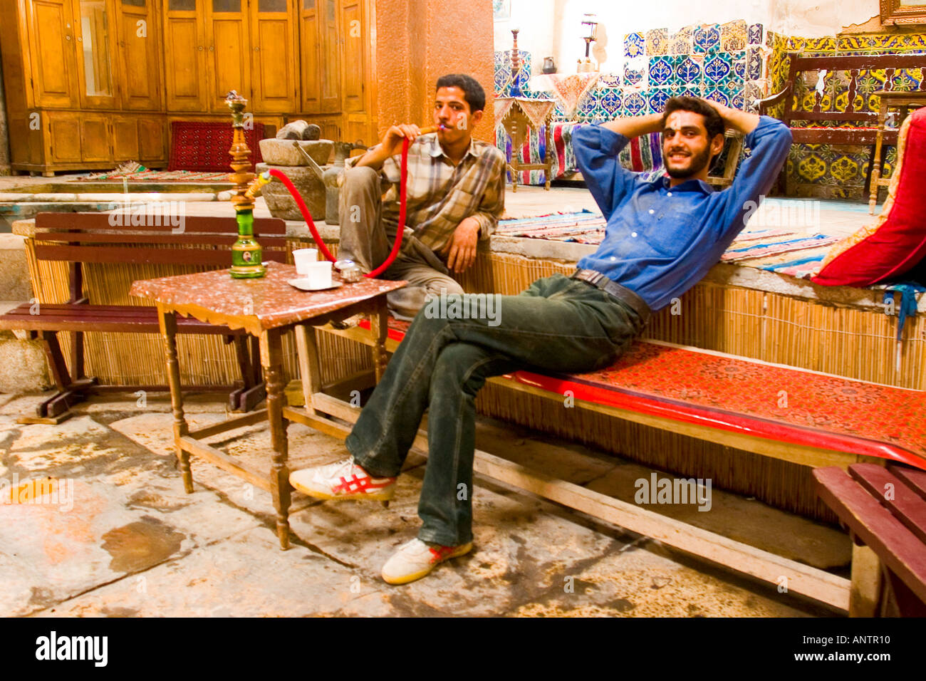 People smoking waterpipe inside teahouse in kashan bazaar Stock Photo