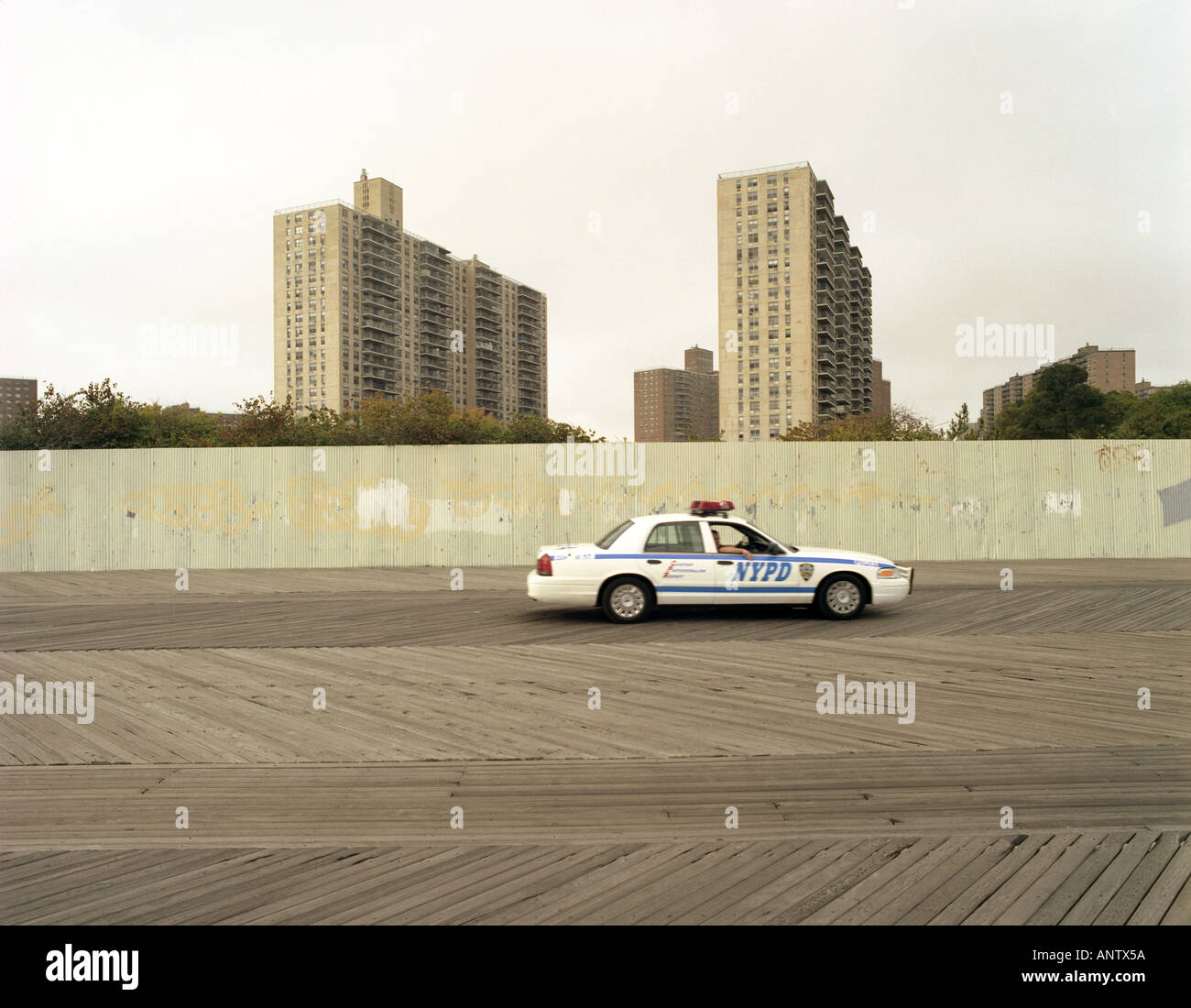 Police car in service during patrol activity along the pathway in front of the sea side at Coney Island beach area New York Us Stock Photo