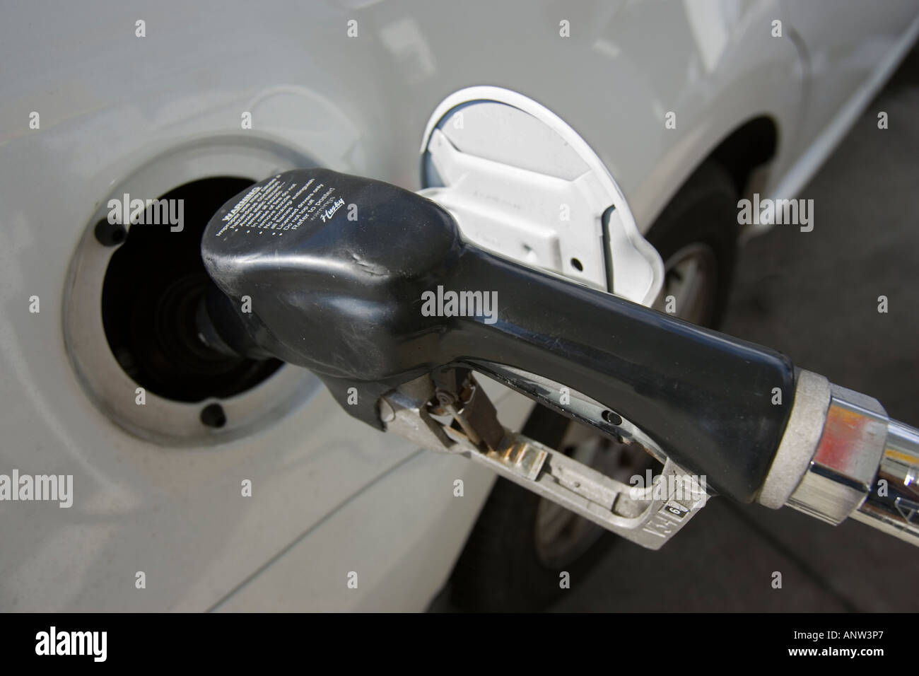 Gas nozzle in a gas tank Stock Photo Alamy