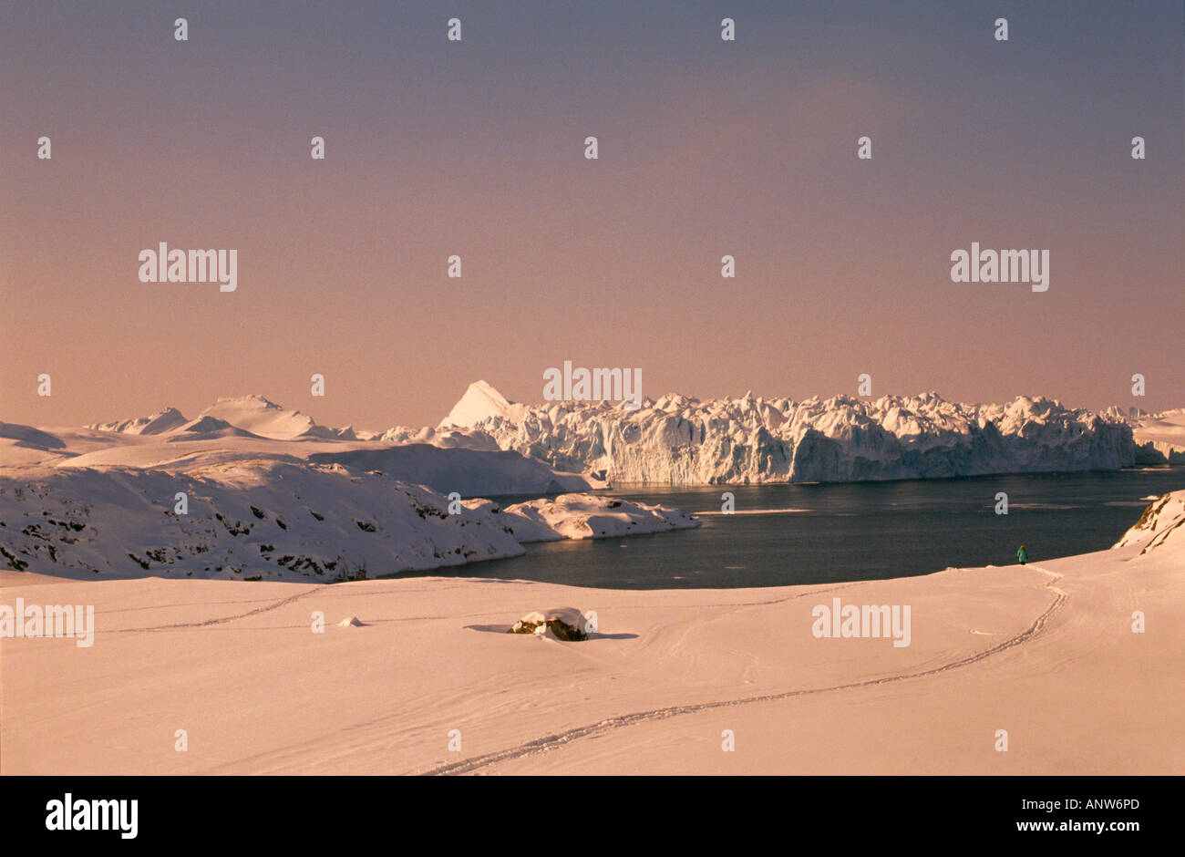track of snowshoe trekker at evening near settlement of ilulissat icefjord greenland danmark Stock Photo