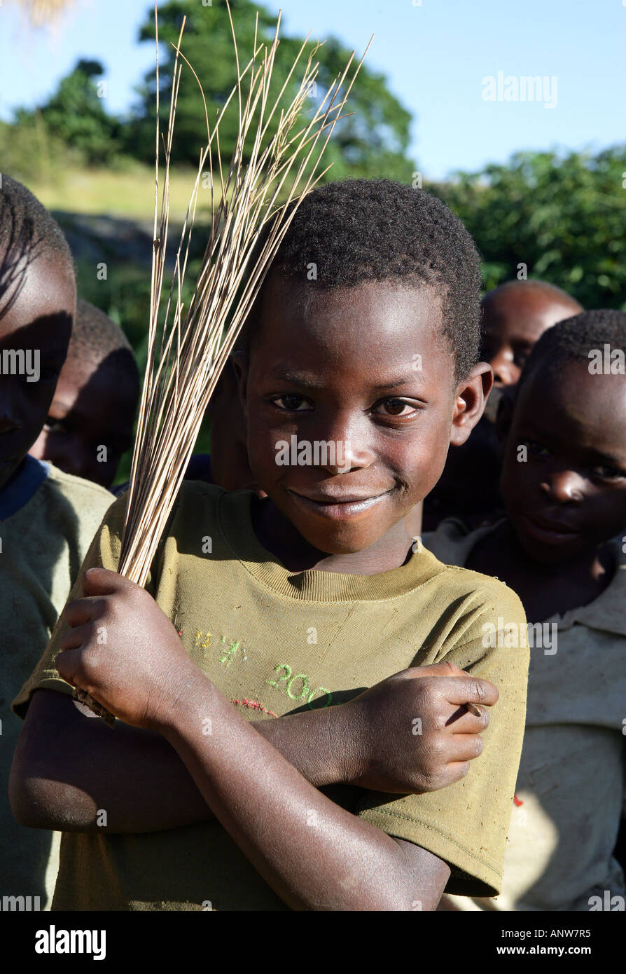 smiling boy with brushwood twigs, Tanzania Stock Photo